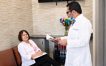 A dentist talking with a patient in the office